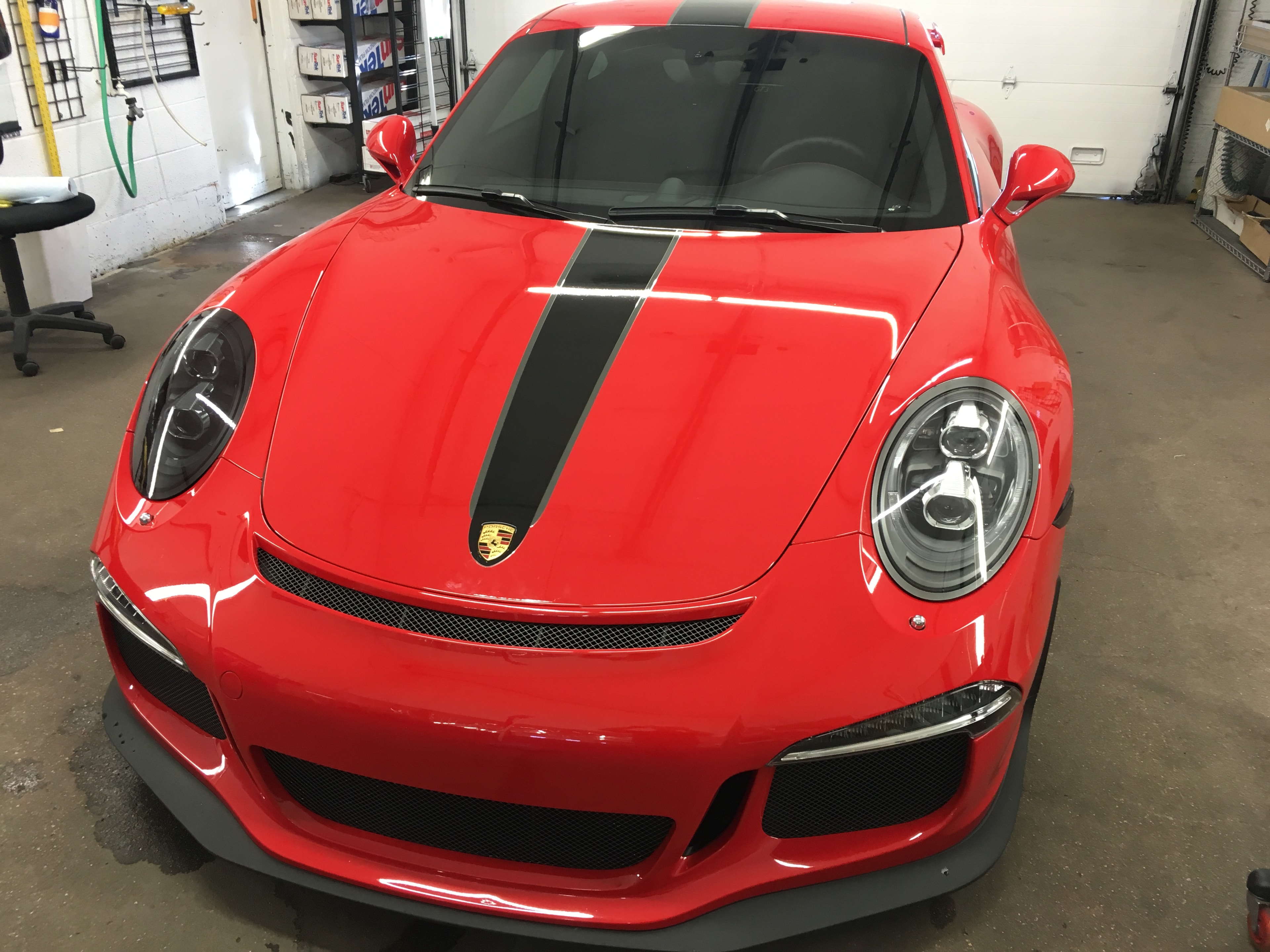 Red Porsche GT3 RS front close-up in garage