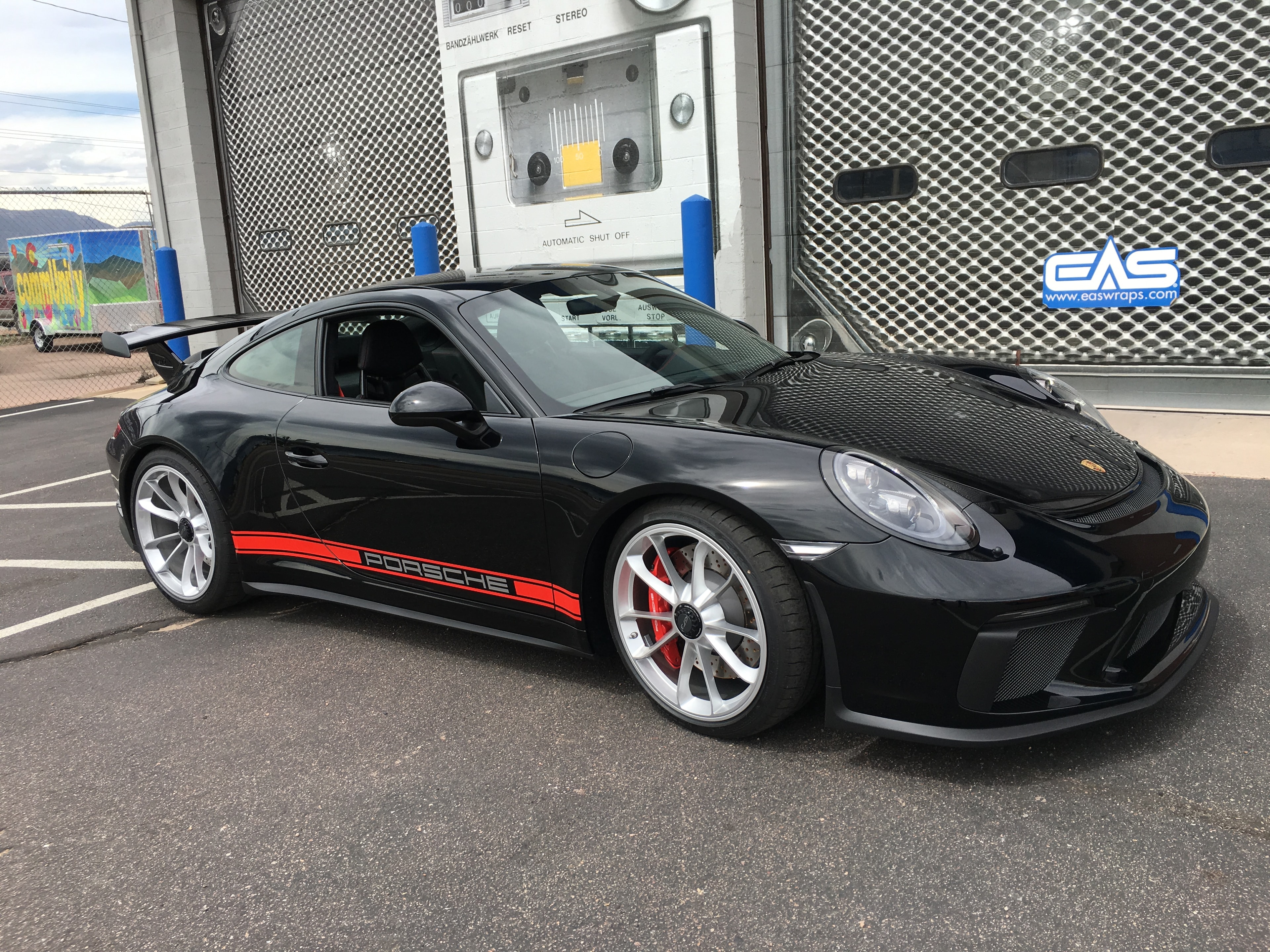 Black Porsche with red stripes